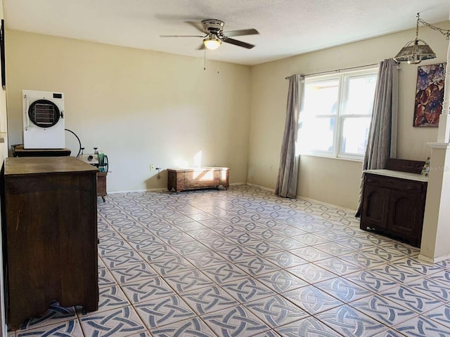 interior space featuring washer / dryer, a textured ceiling, and ceiling fan