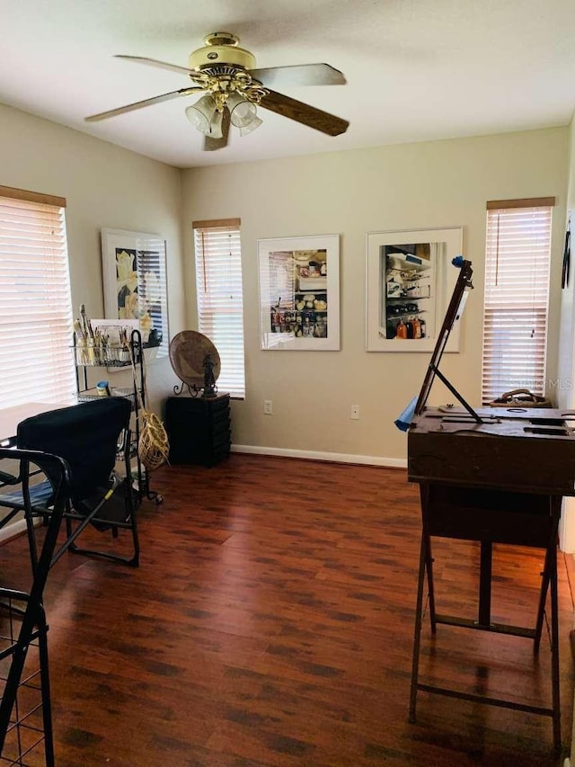 misc room with plenty of natural light, dark hardwood / wood-style floors, and ceiling fan