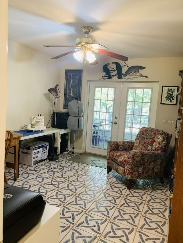 sitting room featuring french doors and ceiling fan