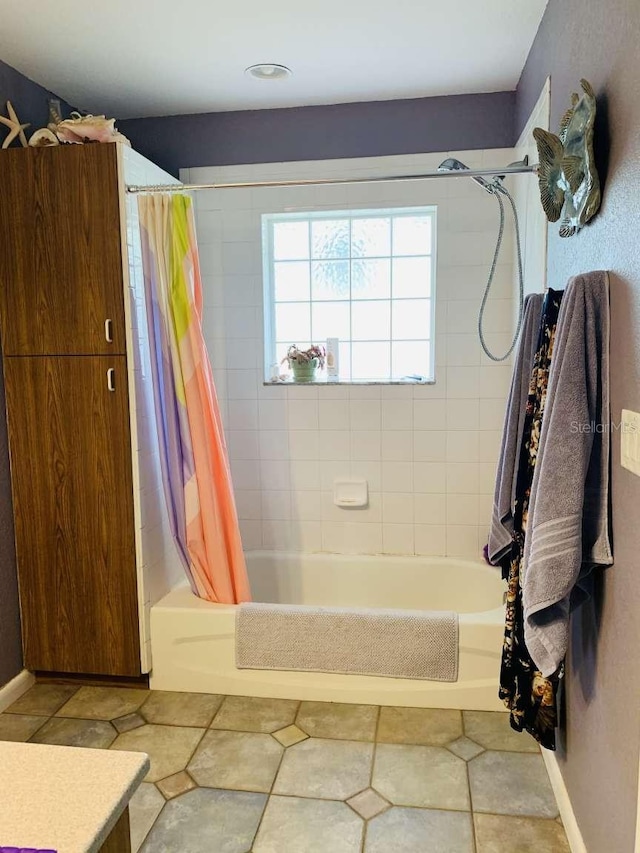 bathroom featuring vanity and shower / bathtub combination with curtain