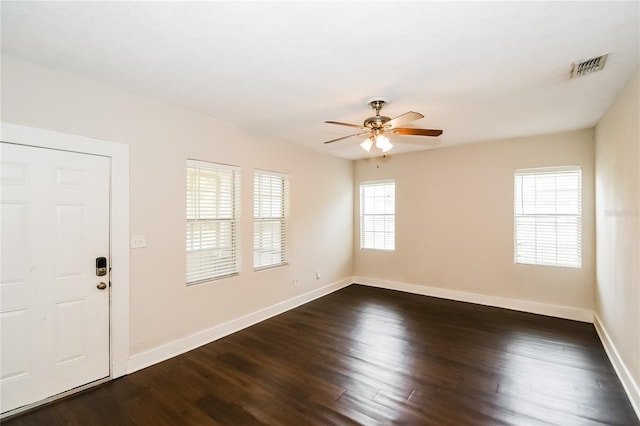 empty room with ceiling fan and dark hardwood / wood-style floors