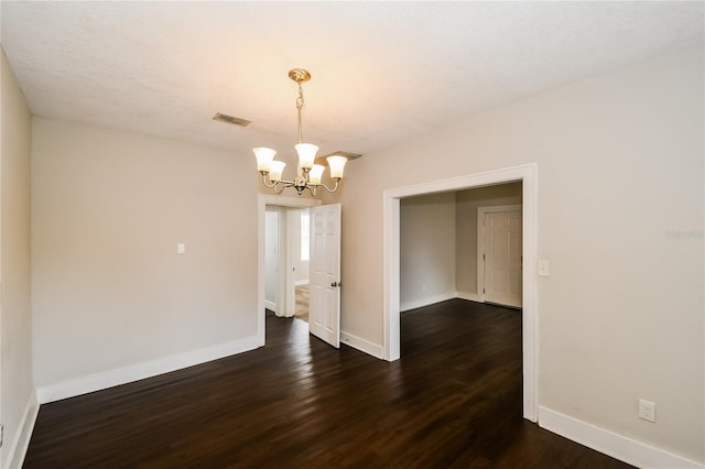 interior space with a notable chandelier and dark hardwood / wood-style flooring