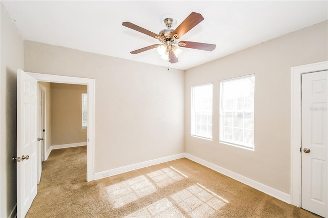 carpeted empty room featuring ceiling fan