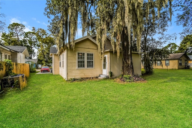 back of house featuring a lawn