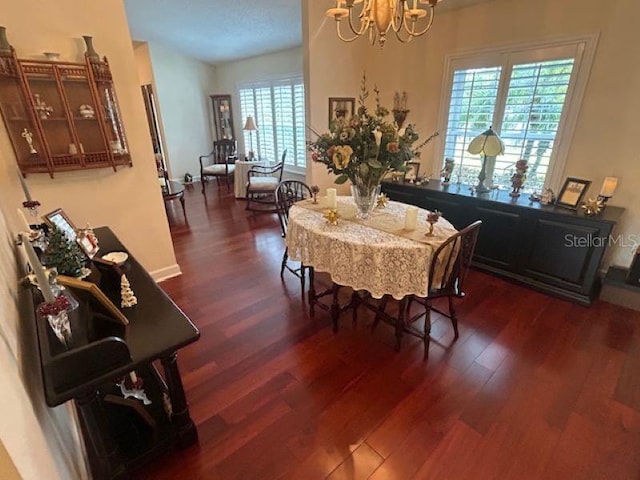 dining room with a chandelier and dark wood-type flooring