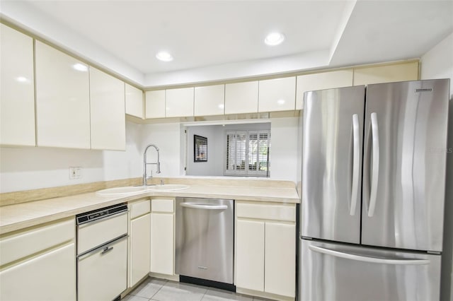 kitchen featuring light tile patterned floors, sink, and appliances with stainless steel finishes