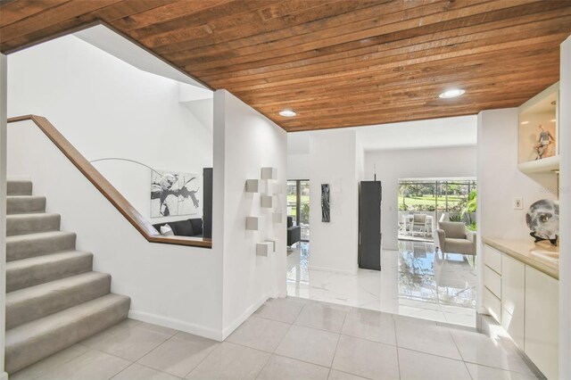 hallway with wooden ceiling and light tile patterned floors