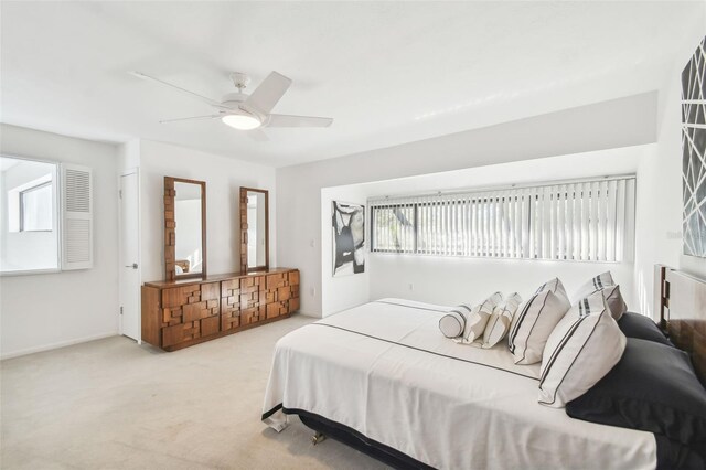 bedroom with ceiling fan and light carpet