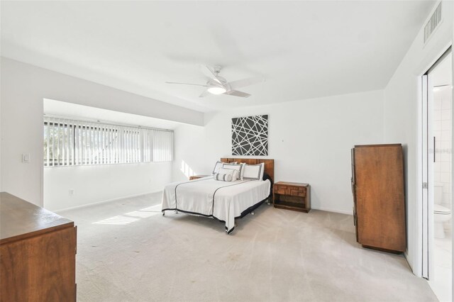 carpeted bedroom featuring ensuite bathroom and ceiling fan