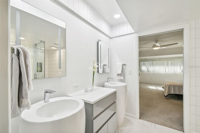 bathroom with vanity, a shower with door, and ceiling fan