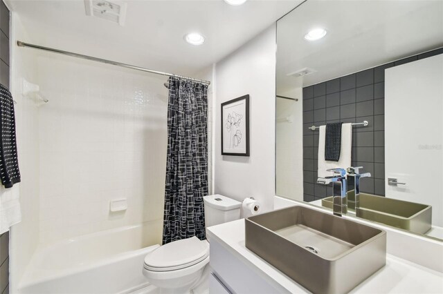 full bathroom with shower / bath combination with curtain, vanity, and toilet