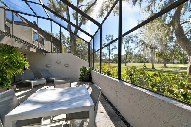 view of patio with glass enclosure