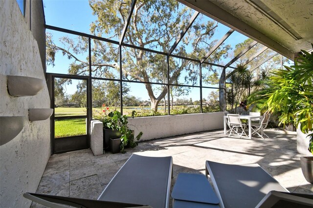 view of patio / terrace featuring glass enclosure