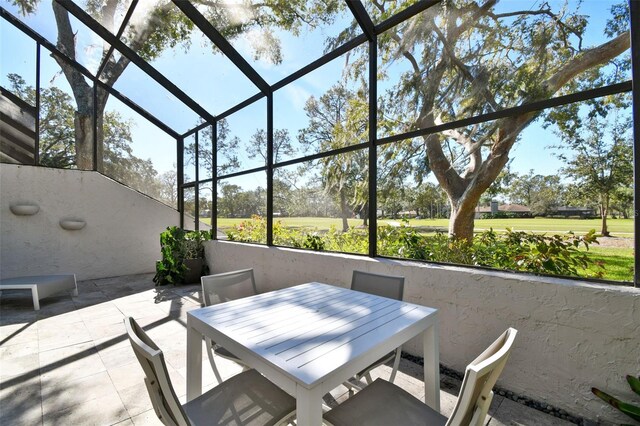 view of patio / terrace featuring a lanai