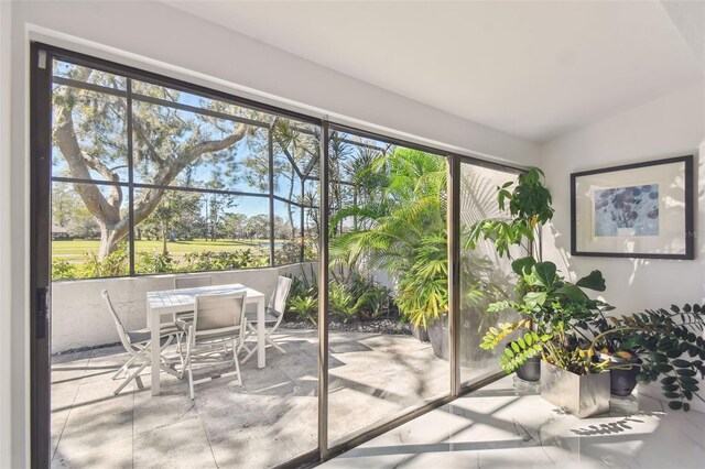 doorway to outside featuring vaulted ceiling