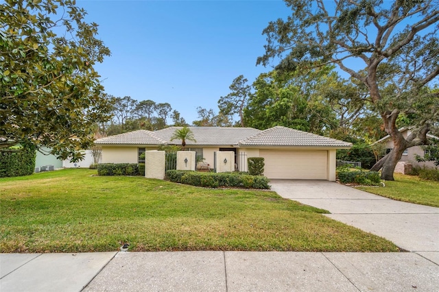 view of front of house with a front yard and a garage