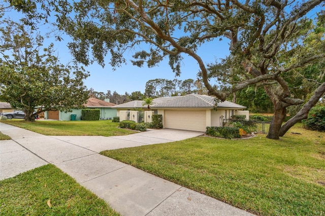 single story home with a garage and a front lawn