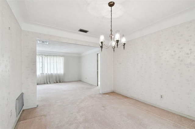 unfurnished room featuring carpet floors and a notable chandelier