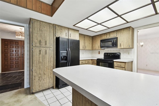 kitchen featuring tasteful backsplash, kitchen peninsula, light tile patterned flooring, and black appliances