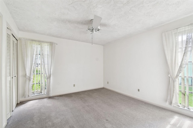 empty room with carpet flooring and ceiling fan