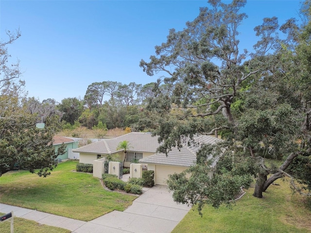 view of front of house with a front lawn and a garage