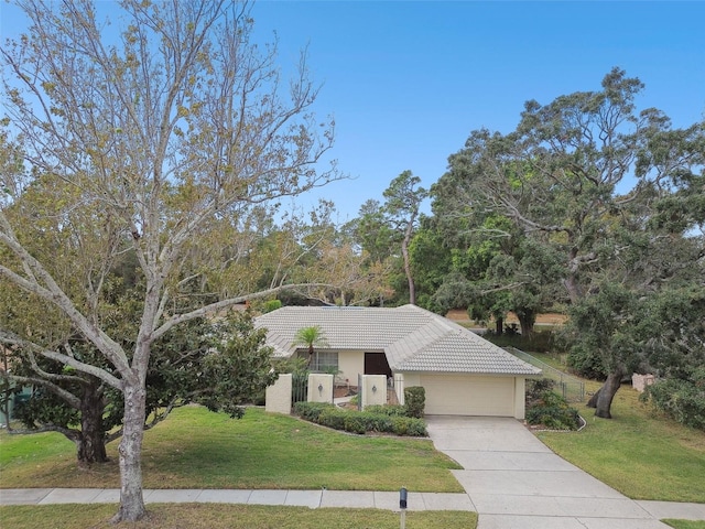 view of front facade with a garage and a front lawn