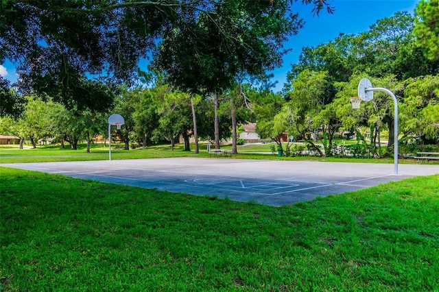 view of sport court with a yard