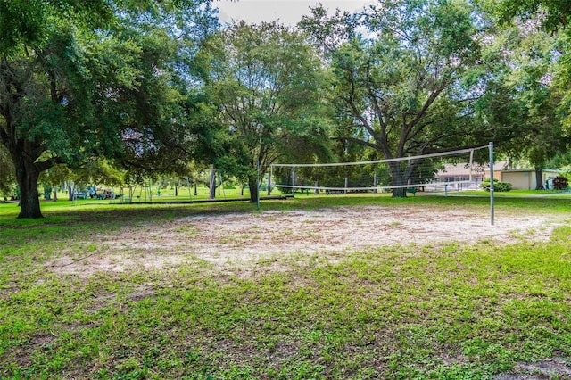 view of home's community with a yard and volleyball court