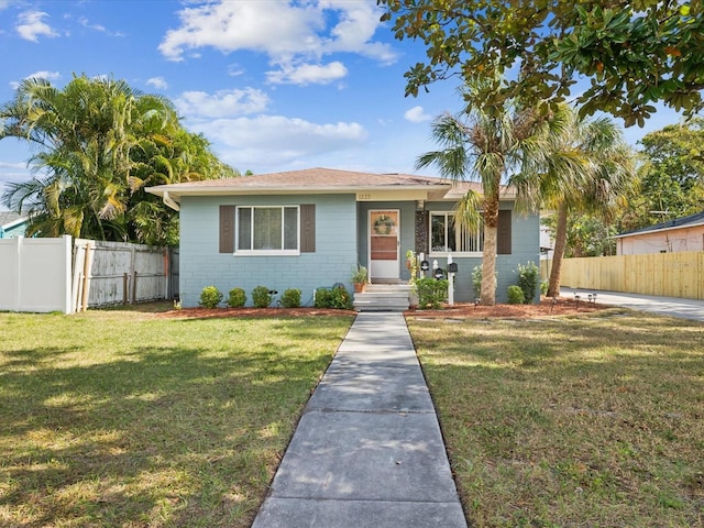 ranch-style home featuring a front yard