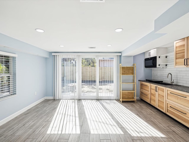 kitchen featuring hardwood / wood-style flooring, sink, and light brown cabinetry