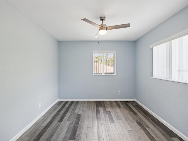 spare room with ceiling fan and dark wood-type flooring