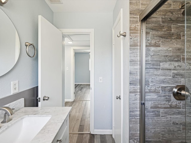 bathroom with vanity, wood-type flooring, and walk in shower