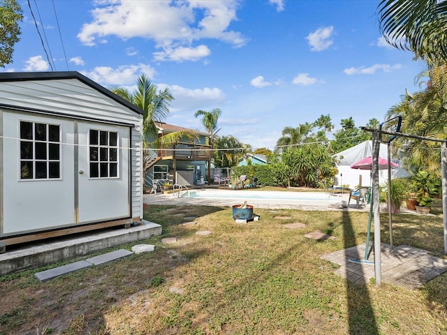 view of yard with a patio and a storage unit