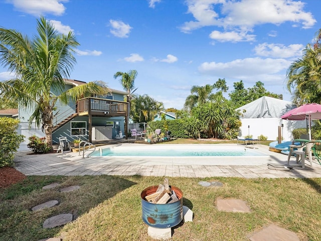 view of swimming pool with a yard and a patio