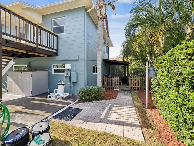 view of side of property with a patio and a deck