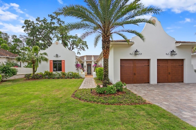 mediterranean / spanish house featuring a front lawn