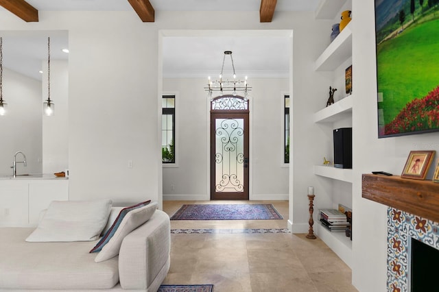 entryway with beam ceiling, a notable chandelier, crown molding, and sink