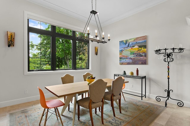 dining room with an inviting chandelier and crown molding