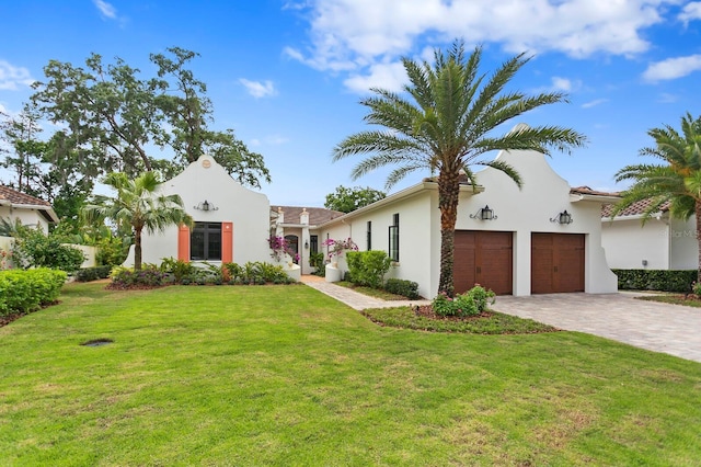 mediterranean / spanish-style home with a front lawn and a garage