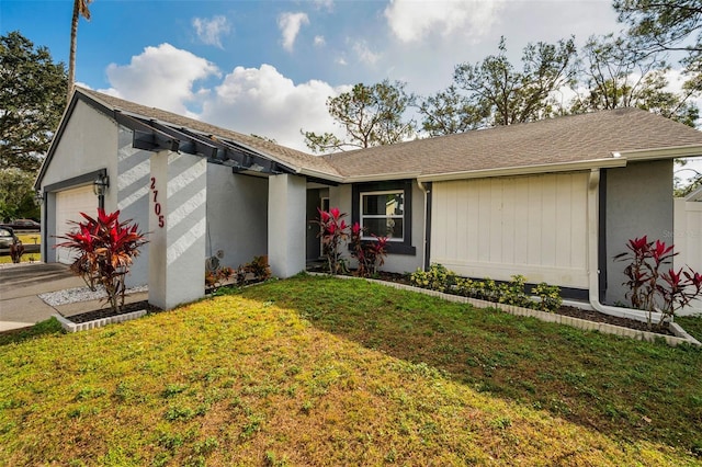 ranch-style home featuring a garage and a front yard