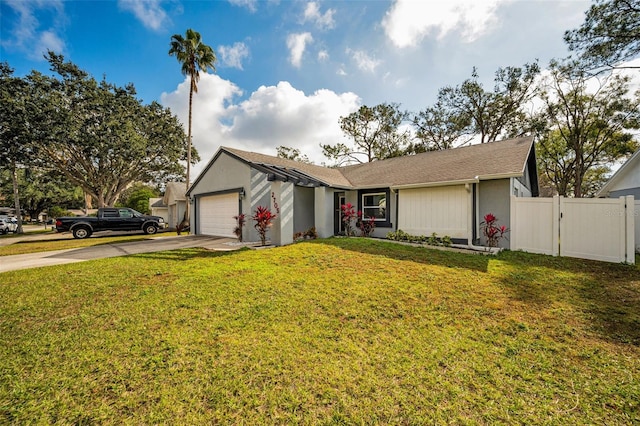 ranch-style home featuring a front lawn and a garage