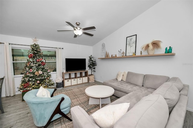 living room with hardwood / wood-style floors, ceiling fan, and lofted ceiling