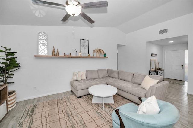 living room with light wood-type flooring, vaulted ceiling, and ceiling fan