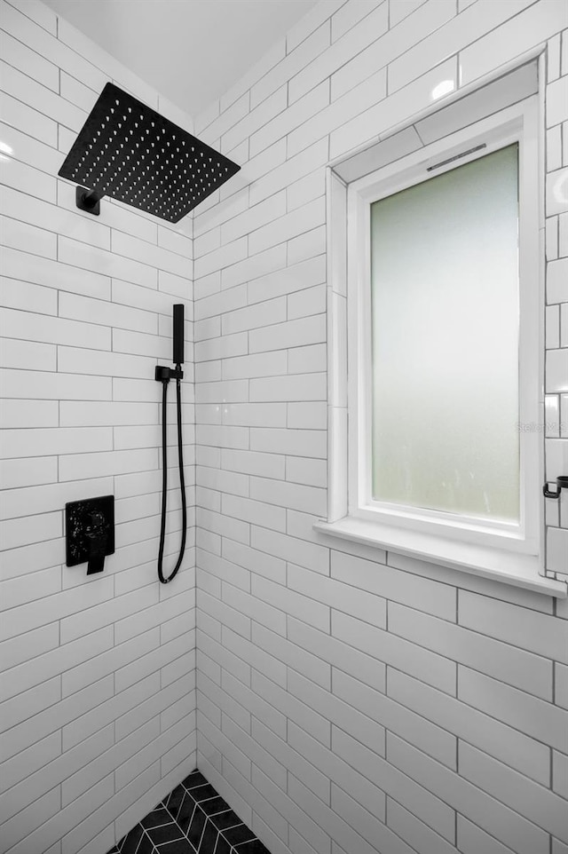 bathroom with a tile shower