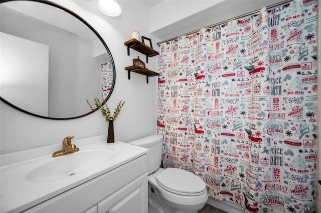 bathroom with vanity, curtained shower, and toilet