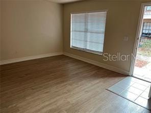 unfurnished room with hardwood / wood-style floors