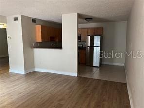 unfurnished living room featuring hardwood / wood-style flooring