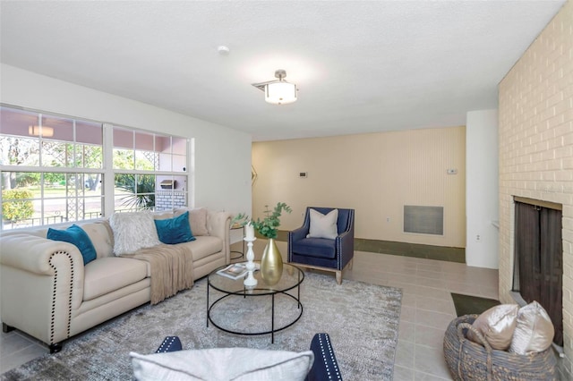 living room featuring a textured ceiling and a fireplace