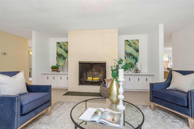 living room with a fireplace and light tile patterned floors