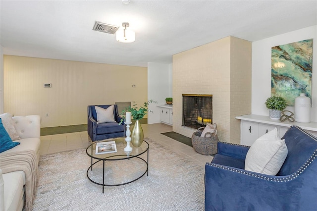 tiled living room featuring a fireplace